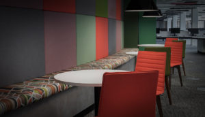 long bench seating area with coloured wall panels