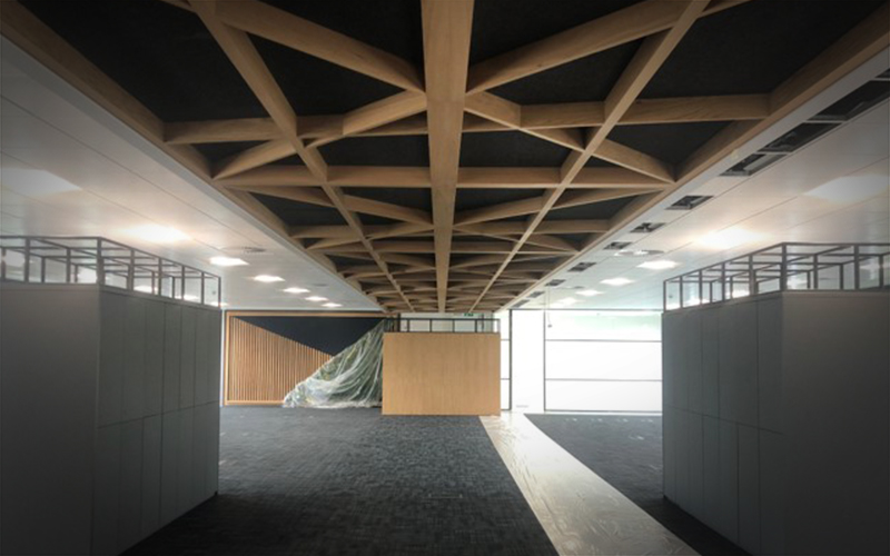 Large acoustic ceiling rafts being suspended.