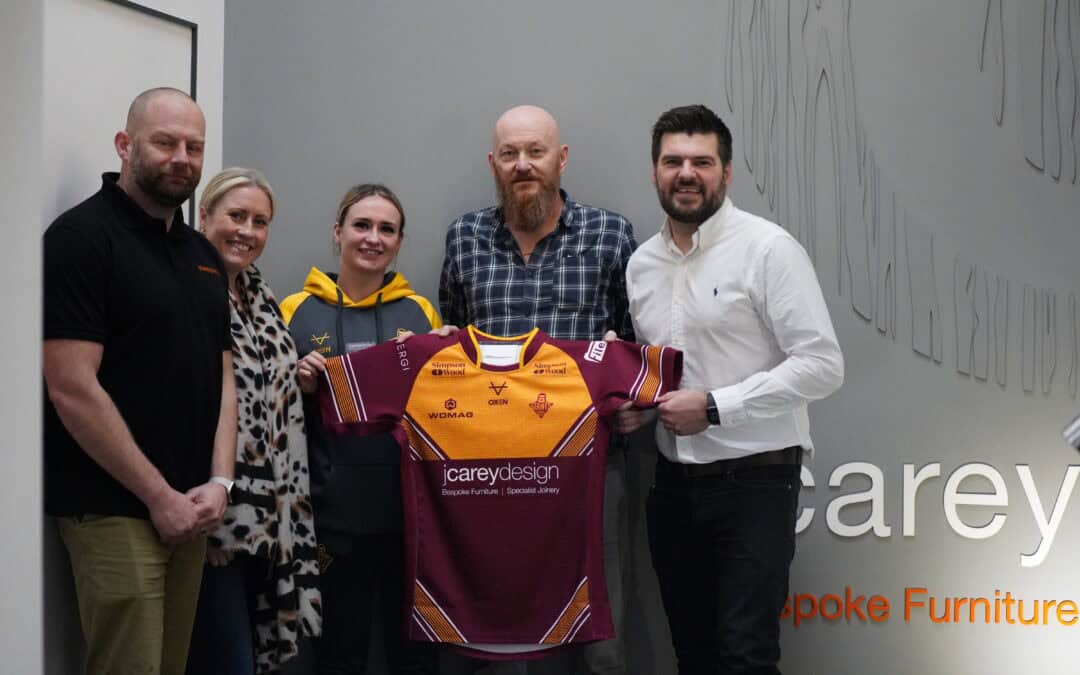 J Carey Design sponsor Huddersfield Giants Women's Team captain, Bethan Oates displaying the new season shirt with directors (L-R) Steve Dent, Laura Tillotson, Steve Ashworth and Richard Tillotson.